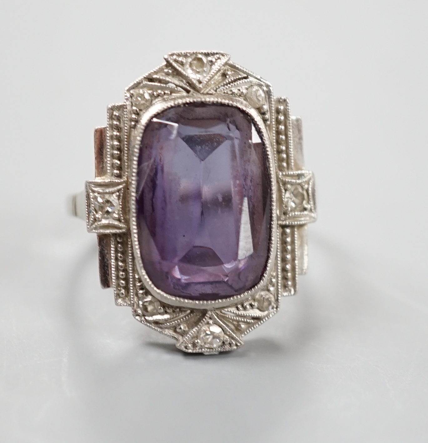 An Art Deco style white metal, synthetic colour change corundum and diamond chip set dress ring, size L/M, gross weight 5.6 grams.
